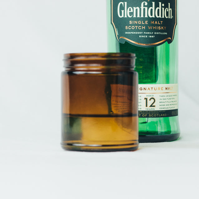 Cleaned and reused glassware being used as a glass to support sustainability.