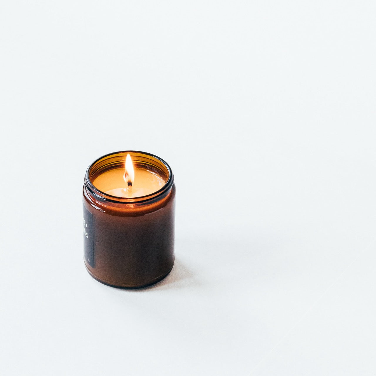 Forest-like candle with blood orange and rich mahogany, evoking late nights and early mornings.