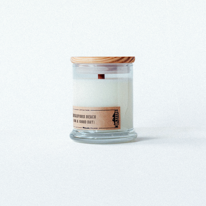 Refreshing candle with dune grass and sunscreen notes, reminiscent of a perfect day at bradford beach.