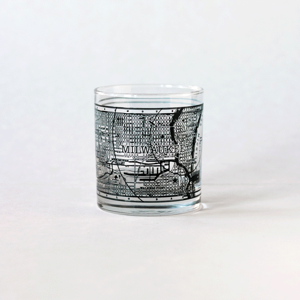 Rotating GIF showing all sides of the 11oz whiskey rocks glass with a screen printed vintage map of Milwaukee. A Milwaukee Candle Co. and Glassnote Candle Bar collaboration.