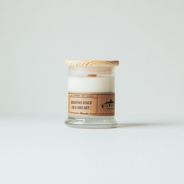 12 ounce Bradford Beach (on a good day) soy wax candle with wood wick, wood lid and kraft paper label. Hand-poured in Milwaukee, Wisconsin.