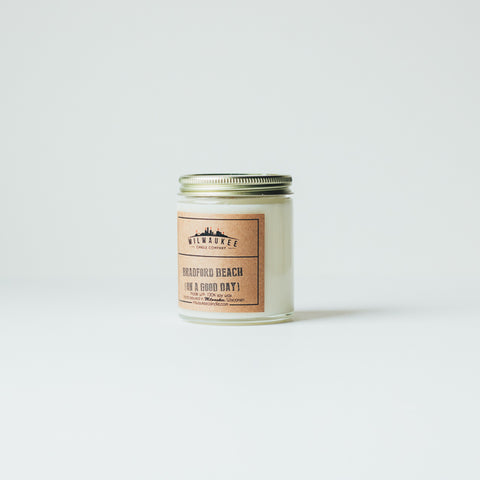 6 ounce Bradford Beach (on a good day) clear jar soy wax candle with kraft paper label and gold lid. Hand-poured in Milwaukee, Wisconsin.