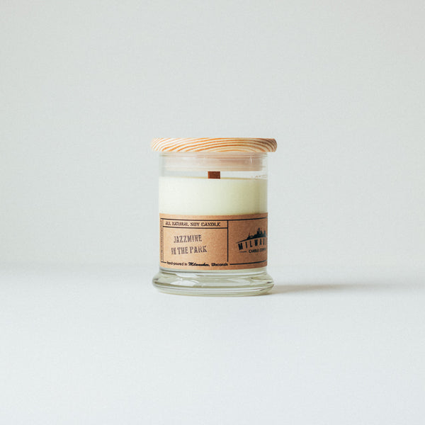 12 ounce Jazzmine in the Park soy wax candle with wood wick, wood lid and kraft paper label. Hand-poured in Milwaukee, Wisconsin.