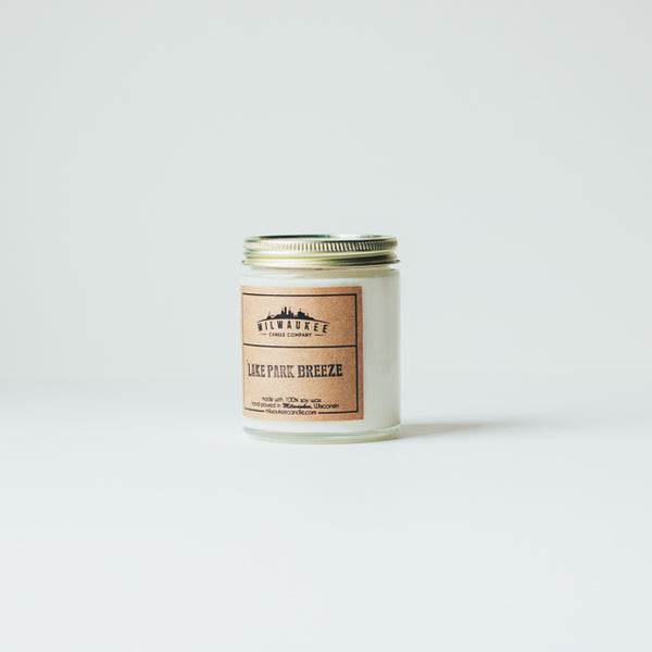 6 ounce Lake Park Breeze clear jar soy wax candle with kraft paper label and gold lid. Hand-poured in Milwaukee, Wisconsin.