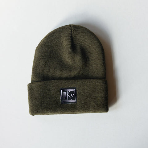 olive green knit beanie with black and white MKE patch 