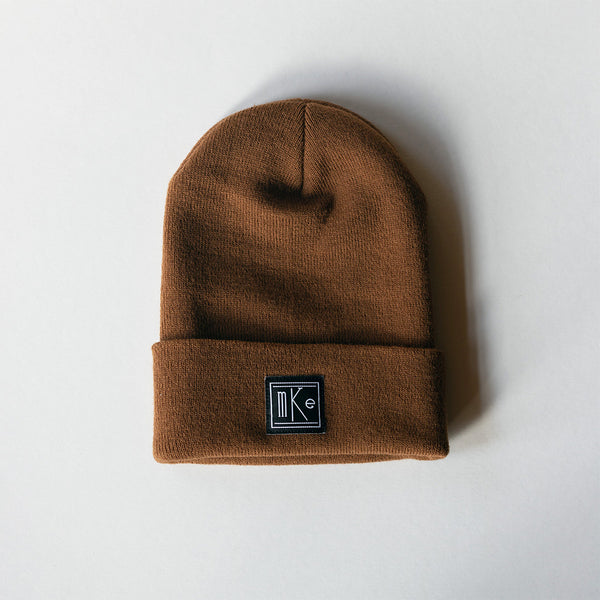 tan knit beanie with black and white MKE patch 